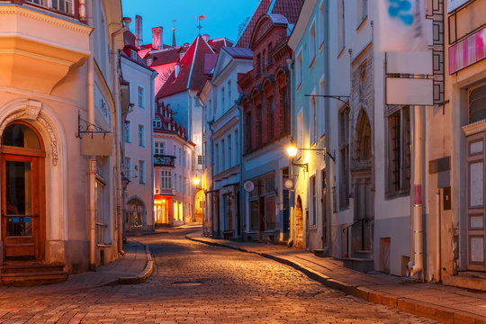 Beautiful illuminated medieval street in Old Town of Tallinn during evening blue hour, Estonia © Kavalenkava