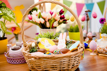 Close up portrait of wooden basket with easter composition, sweets, choco, gingerbread standing on...