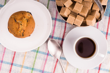 Fresh muffin with berries and a cup of coffee - top view