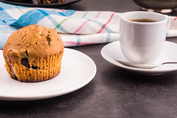 Homemade muffin with berries and a cup of coffee - top view