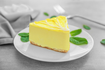 Plate with tasty souffle cake on grey table