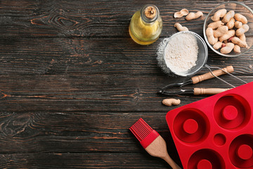 Kitchen utensils and ingredients for pastries on wooden background
