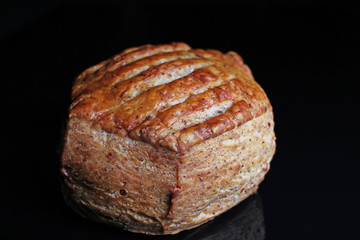 Scone. Pastry round scone on black reflective studio background. Isolated black shiny mirror mirrored background for every concept.
