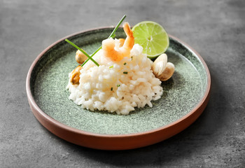 Plate with delicious seafood risotto on table