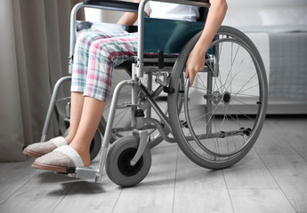 Fototapeta na wymiar Girl in wheelchair indoors