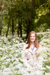 Fototapeta na wymiar Happy woman in the green spring blossoming park