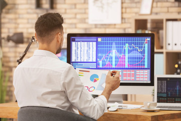 Young stock exchange trader working in office