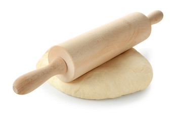 Raw dough and rolling pin on white background
