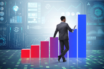 Businessman standing next to bar chart in business concept