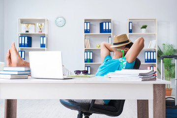 Businessman preparing for vacation in the office