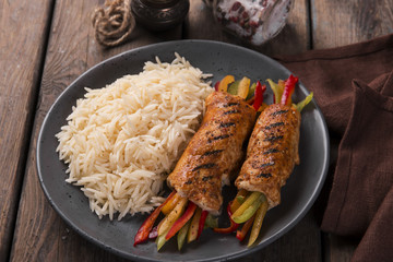 Grilled chicken rolls from chicken fillet stuffed sweet peppers