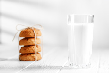 A glass of milk and delicious oatmeal cookies. The concept is healthy food, breakfast, vegetarianism.The concept is healthy food, breakfast, vegetarianism.