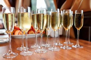 Rows of champagne and wine glasses on alcohol party and wedding reception