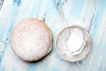 Traditional Polish donuts on wooden powder. Tasty doughnuts with jam.