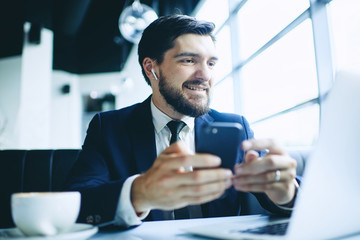 businessman in cafe with telephone