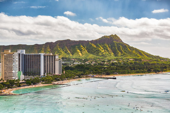 Hawaii vacation travel aerial view of Waikiki beach and Honolulu city with Diamond Head mountain in background. Urban landscape for USA travel summer vacation destination.