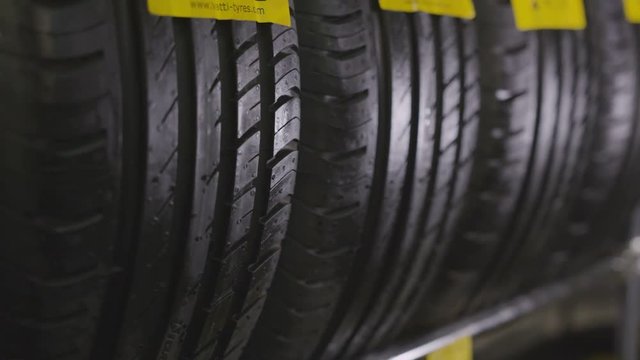 Tires with Deep Protectors Stand on Shelf Closeup
