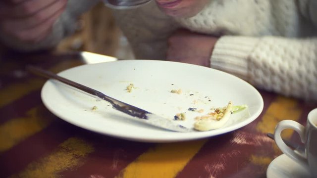 Finish eating food in restaurant . the man is eating crumbs with plates in the restaurant. 4k
