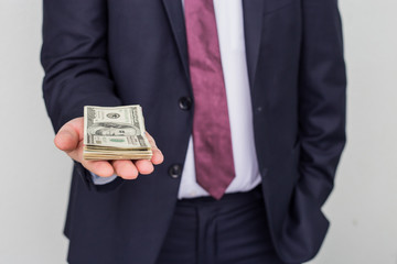 A businessman shows a sum of cash on his palm