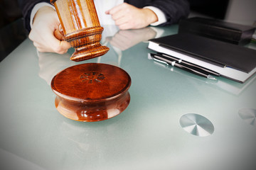 Auctioneer prepared to hit the gavel in order to decide the auction winner

