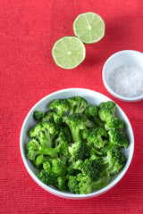 Bowl of cooked broccoli with seasonings