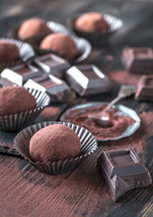 Rum balls with cocoa powder and chocolate slices