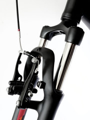 Front suspension of bicycle isolated on white, unusual angle