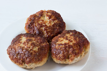Homemade cutlets on a plate.