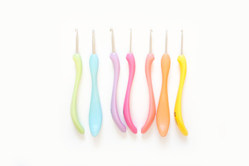 Crochet hooks and yarn color. White background.