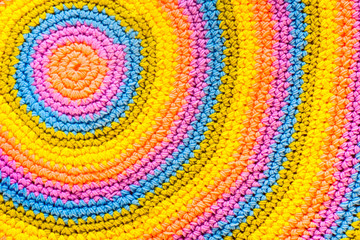 Colorful round yarn mat. Crochet. Yarn in coils and tangles. White background.