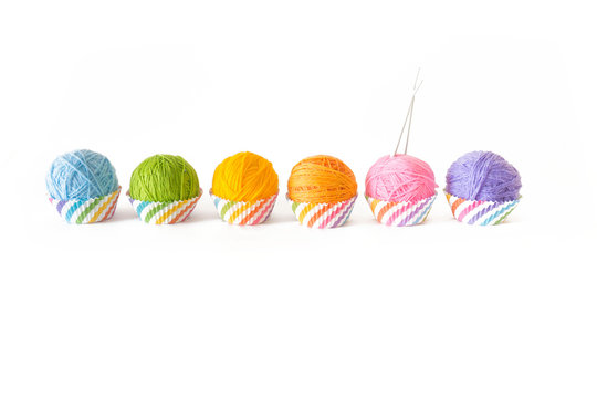 Colored yarn in the form of capkeys or mafins. Colors of rainbow. Isolate. White background.