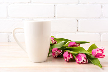 Fototapeta na wymiar White coffee latte mug mockup with rich pink tulips bouquet