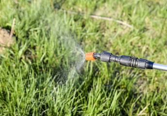 Spraying herbicide from the nozzle of the sprayer manual