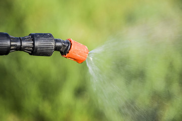 Spraying herbicide from the nozzle of the sprayer manual