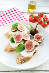 fresh ripe sliced fig on toast bread mozzarella cheese Italian crostini dish light lunch starter
