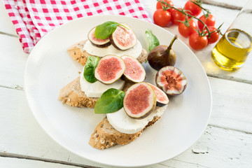 fresh ripe sliced fig on toast bread mozzarella cheese Italian crostini dish light lunch starter