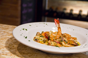 Garlic Prawns and butter sauce served in a ceramic plate