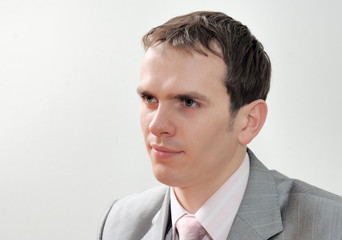 Closeup headshot portrait, serious, handsome, confident, young business man isolated on white background. 