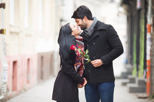 Young beautiful couple kissing on the street