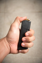 Fototapeta premium hand loading 9mm bullets into the gun magazine