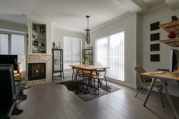 Luxury dining room, fireplace and a small office. Interior design.
