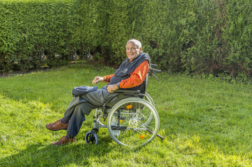 smiling happy senior man sitting in his garden