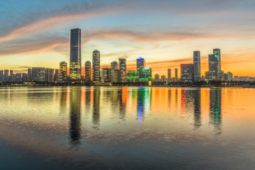 Fototapeta na wymiar modern city waterfront downtown skyline under colorful dramatic sky,China