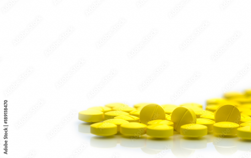 Wall mural yellow tablets pills isolated on white background with copy space. pile of medicine. painkiller tabl