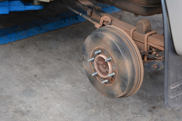 a part of car wheel with lifter machine  in the repair shop