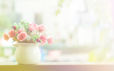 Rose flower and floral in a pot soft blur background in pastel tones.