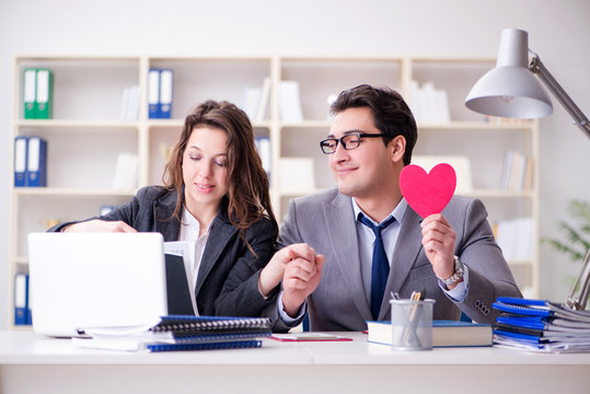 Happy couple working in the same office