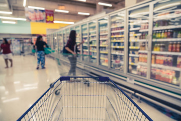 Abstract blurred photo of store with trolley in department store bokeh background, business supermarket and shopping blurred and background concept