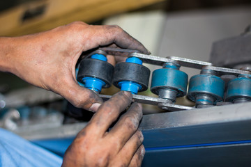 The technician repairing conveyor belt in factory