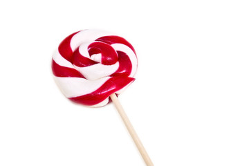 Red and white lollipop in the shape of a circle on the white background.